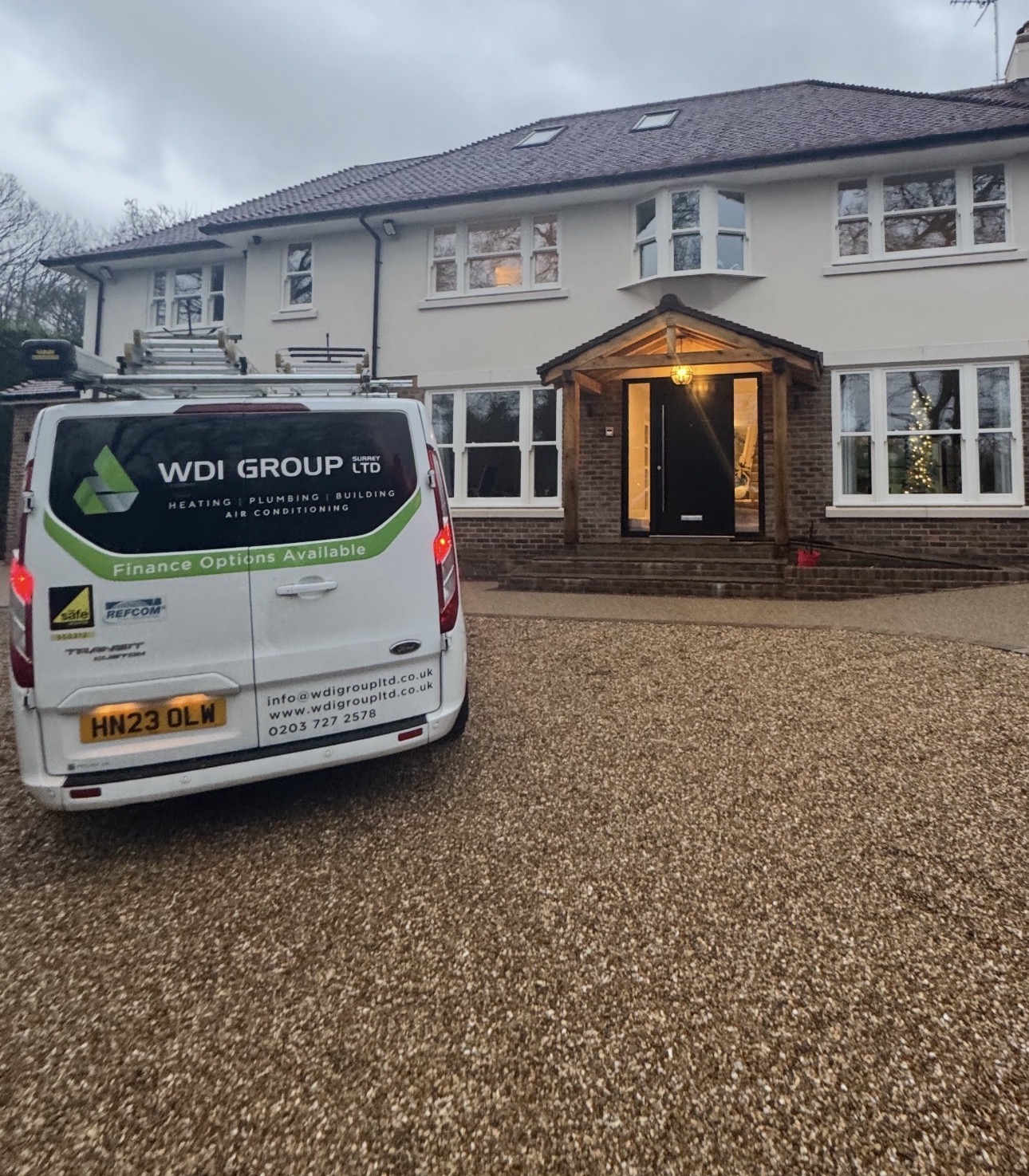 WDI Group (Surrey) Ltd van outside a large Surrey home
